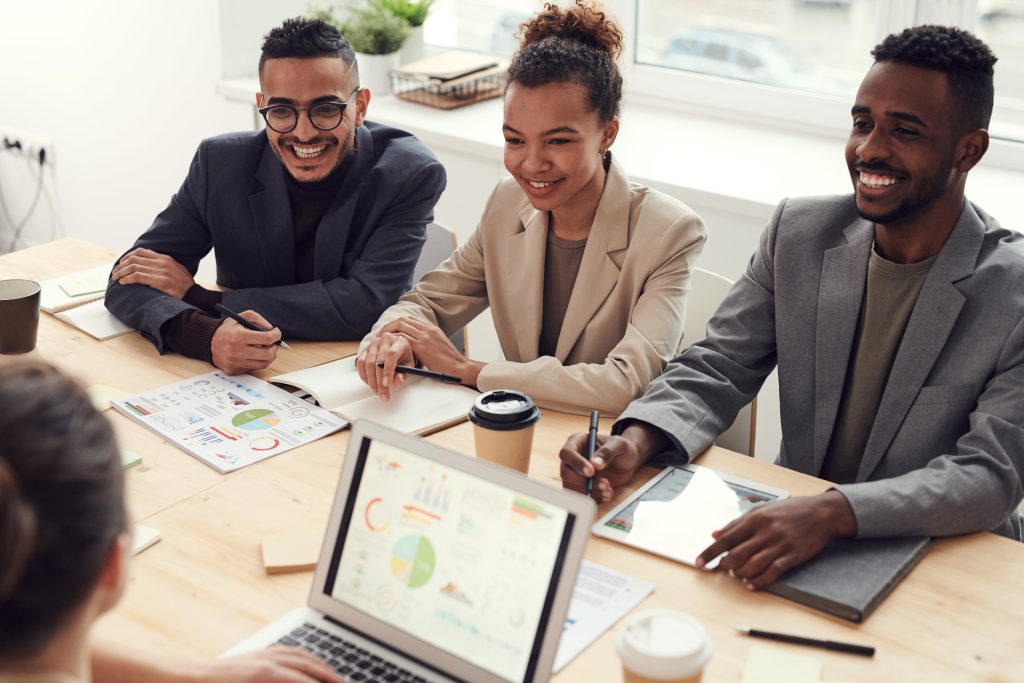 Business people wearing suits in meeting sitting at conference table