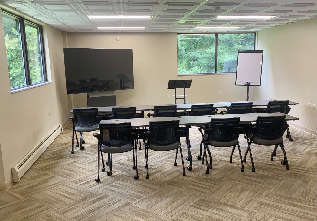 small conference room with monitor and easel